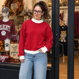 Blank Mockneck Sweatshirt — Preorder | Multiple Colors, woman wearing a red mocknech sweatshirt with white collar and cuffs, in a retail store.