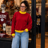 Blank Mockneck Sweatshirt — Preorder | Multiple Colors, young woman in red sweatshirt with yellow cuffs and collar, standing outside a store with apparel and autumn decor
