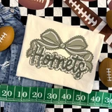 Camo Bow School Mascot DTF Heat Transfer, beige fabric with a bow and the word 'Horners' printed on it, surrounded by football-themed items.