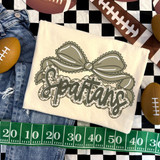 Camo Bow School Mascot DTF Heat Transfer, detailed camouflage bowtie design with the word 'Star' in scripted font, displayed on a fabric with football and measuring tape accessories.