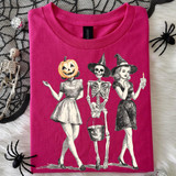 Vintage Halloween Trio DTF Heat Transfer, T-shirt with a spooky vintage Halloween illustration featuring a girl with a pumpkin head, skeleton in a witch hat, and a woman dressed as a witch holding a candle.