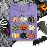 Patterned Pumpkins DTF Heat Transfer, colorful Halloween-themed pumpkin designs on a lavender t-shirt.