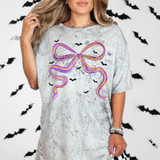 Halloween Coquette Bow DTF Heat Transfer, vibrant purple and orange bow design on gray T-shirt with black bat silhouettes for Halloween-themed fashion.