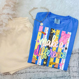 Make A Difference DTF Heat Transfer, colorful school-themed design on a blue T-shirt with rulers, stars, and a pink bow graphic, displayed alongside beige shorts and a silver necklace.