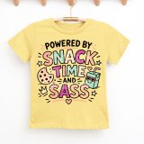 Powered By Snack Time & Sass DTF Heat Transfer, colorful and playful design on a yellow children's T-shirt.