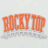 Rocky Top Football Puff Embroidered & Glitter Hat Patch, embroidered patch featuring the word 'ROCKY TOP' in orange puff embroidery with silver glitter outline and a white embroidered football lace design.