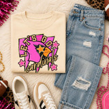 Pink Glitter Mascot - 62 teams - DTF Heat Transfer, a colorful and sparkling design featuring a pink mascot head with stars, on a beige sweatshirt surrounded by casual clothing and accessories.