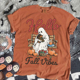 Hello Fall Vibes Ghost DTF Heat Transfer, orange t-shirt featuring a ghost holding a dog on a swing with pumpkins, apples, a book, and a mug, fall-themed design.