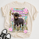 Jesus Loves You Lamb DTF Heat Transfer, illustrated black lamb with floral accents and colorful text on a cream T-shirt.