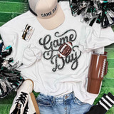 Game Day Sequin Patch With Football, embellished patch on white t-shirt with game day theme, surrounded by cheerleading pom-poms, sneakers, and brown tumbler on green background.