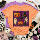 Painted Halloween Collage DTF Transfer, Halloween-themed orange T-shirt with jack-o'-lanterns, ghosts, a witch's hat, a bat, and candles on a purple background.