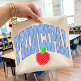 Gingham Apple School Staff DTF Heat Transfer, colorful school bag with gingham apple design and bold lettering, for educational or staff apparel customization.