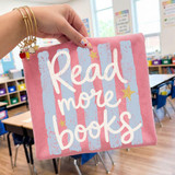 Read More Books DTF Heat Transfer, pink fabric with white and light blue text and decorative stars, showcasing a custom heat transfer design on a classroom setting.