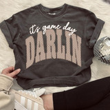 It's Game Day Darlin' WHITE DTF Heat Transfer, white and pink polka dot design on a black sweatshirt.