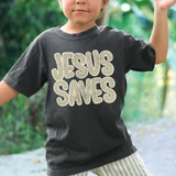Jesus Saves TAN DTF Heat Transfer, colorful heat transfer decal on child's black t-shirt in outdoor setting