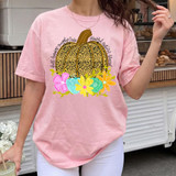 Colorful Fall Floral Pumpkin DTF Heat Transfer, vibrant pumpkin with floral accents and handwritten words, on a light pink t-shirt.