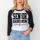 Senior Band Mom 2027 Music Notes DTF Heat Transfer, a woman wearing a black and white raglan shirt with a musical themed design for a senior band mom.