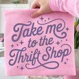 Take Me To The Thrift Shop LAVENDER DTF Heat Transfer, purple decorative text on pink fabric background with sparkles
