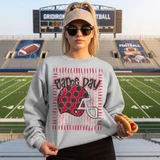 Game Day Polka Dot Helmet DTF Transfers | Football Color Combo Collection, girl wearing a sweatshirt with football themed design in a stadium.