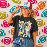 Neon Star Mascot DTF Transfers | School Spirit Mascot Collection, colorful neon star mascot design on a t-shirt worn by a woman, with a background of football-shaped smiley face decorations.