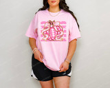 Pink Football Pumpkin with Bow DTF Heat Transfer, a vibrant pink pumpkin graphic with a bow and football lacing details on a light pink T-shirt.