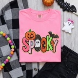 Colorful Spooky sequin heat press patch with pumpkin ghost spiderweb and bat details on pink shirt