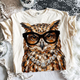 Glam owl DTF transfer with oversized black glasses and jeweled necklace displayed on cream Comfort Colors T-shirt