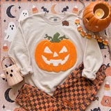 Fluffy Jack O’ Lantern Patch, Halloween heat press patch featuring a fluffy orange pumpkin with a classic carved face and green vine on white sweatshirt with orange tie-dye accents.