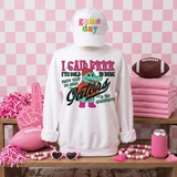 Brrrr It's Cold Out Mascots DTF Transfers | Winter Mascot Collection, colorful mascot T-shirt with alligator character and playful text, surrounded by pink sports accessories in a themed display.