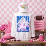 Loud & Proud Mascot DTF Transfers | Retro School Spirit Mascot Collection - White sweatshirt with a vibrant cartoon mascot graphic and the text 'LOUD' and 'el Proud', displayed with pink and sports-themed accessories and a pink checkered background.