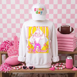 Loud & Proud Mascot DTF Transfers | Retro School Spirit Mascot Collection, white sweatshirt with a vibrant graphic of a muscular mascot holding a barbell and the words "Loud & Proud," displayed among pink-themed football accessories and decorations.