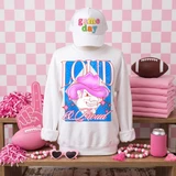 Loud & Proud Mascot DTF Transfers | Retro School Spirit Mascot Collection featuring a white sweatshirt with a vibrant cartoon mascot design and colorful lettering, paired with a white cap, pink accessories, and sports-themed items, set against a pink checkered background.