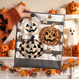 Halloween DTF transfer with three jack-o'-lantern pumpkins in checkered, leopard print, and gold patchwork patterns over grey and white stripes
