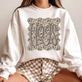 Camo Mascot DTF Transfers E-O | School Spirit Mascot Collection, embedded on a white sweatshirt worn by a person, featuring a camouflage pattern with the text 'SPURS' in stylized letters.