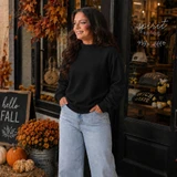Blank Mockneck Sweatshirt — Preorder | Multiple Colors, black mockneck sweatshirt worn by a woman with autumn decorations outside a boutique store.