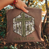 Hooked On Jesus DTF transfer with camo hexagon background, painted green cross, and hanging fishing lures design