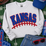 Red and blue Kansas football chenille patch with bold varsity lettering and football lace design for game day apparel