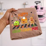 Happy Hallothanksmas DTF transfer featuring a caramel apple, pumpkin pancakes, and a gingerbread man walking across a crosswalk with fall and holiday icons