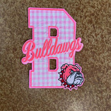 Pink Gingham Bulldawgs Appliqué Embroidered Patch, features a large pink and white gingham letter 'B' with the word 'Bulldawgs' embroidered in pink cursive across it, and a detailed bulldog mascot embroidered at the bottom right corner.
