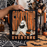 Ghosting Everyone Halloween DTF transfer with distressed orange lettering and a cozy ghost reading a book beside a stack of books