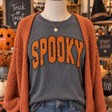 Orange and black polka dot SPOOKY corduroy appliqué patch with embroidered edging shown on charcoal Halloween shirt