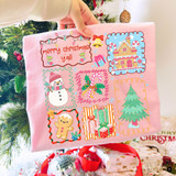 Merry Christmas Y'all Christmas DTF transfer with pastel grid design featuring a gingerbread house, snowman, candy cane, gingerbread man, presents, and Christmas tree on a pink shirt