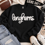 White Longhorns fluffy heat press appliqué patch with script lettering displayed on a black sweatshirt.