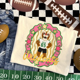 Idalou Wildcats mascot DTF transfer featuring a wildcat mascot in a football jersey inside a pink and gold star-studded frame with "Wildcats" script lettering