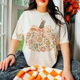 Floral pumpkin DTF transfer with gingham bow and fall-colored ditsy flower pattern on a cream t-shirt
