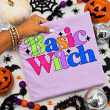 Basic Witch DTF transfer with bold retro rainbow lettering and black star accents on a lavender shirt
