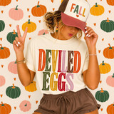 Deviled Eggs DTF transfer in retro multicolor varsity lettering on a cream t-shirt