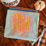 Retro turkey DTF transfer with pink outline, gold striped feathers, and orange and pink paint splatter accents on a mint shirt