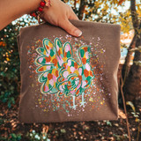 Colorful mosaic turkey DTF transfer with paint splatter effect in green, pink, orange, and gold tones on a shirt