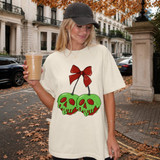 Poison apple skulls DTF transfer with dripping green and red skull apples tied together with a red bow, Snow White inspired design